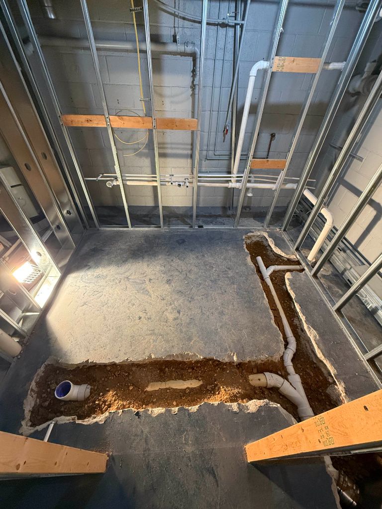 Underground plumbing trench cut through concrete floor