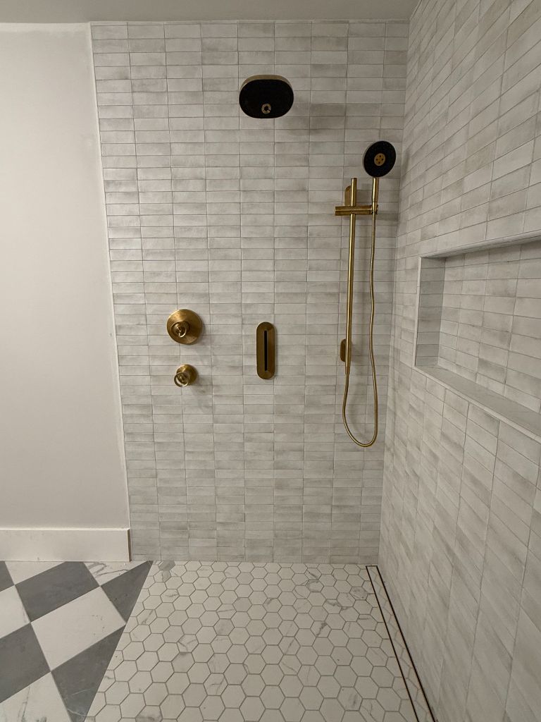 Custom gold-fixture walk-in shower completed by Legacy Plumbing Co.