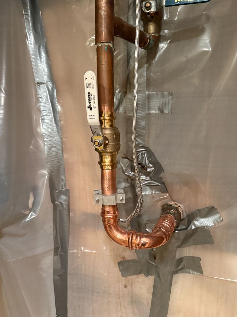 Copper pipe with ball valve installation in crawlspace