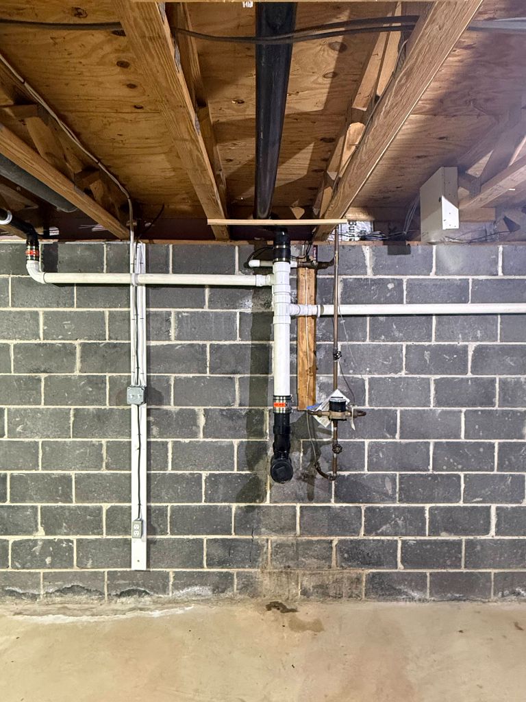Basement plumbing rough-in on block wall