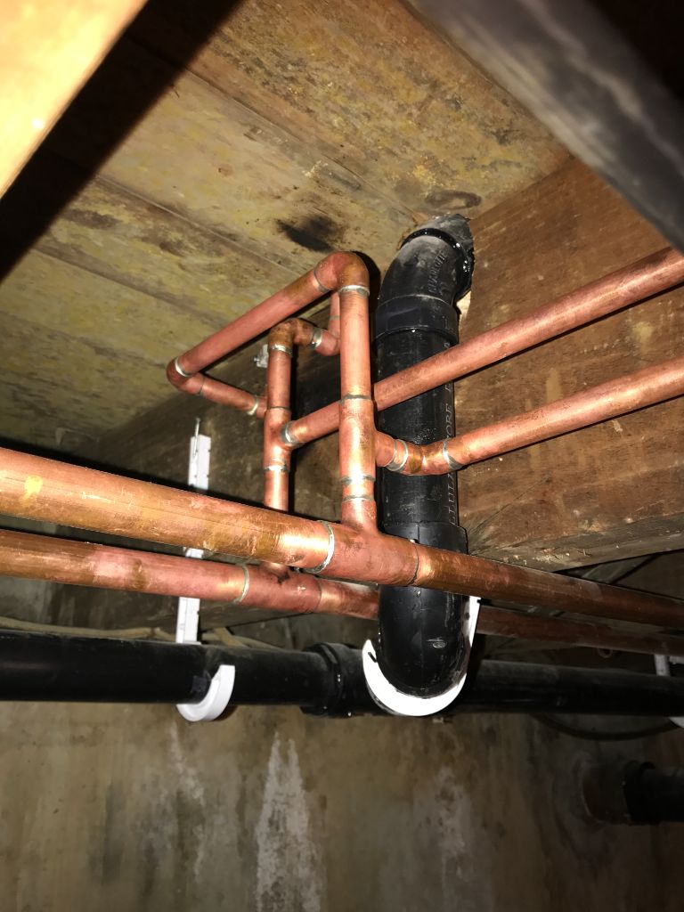 Copper pipe and drain rough-in in crawlspace