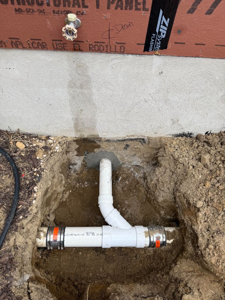 PVC sewer pipe exiting through foundation wall