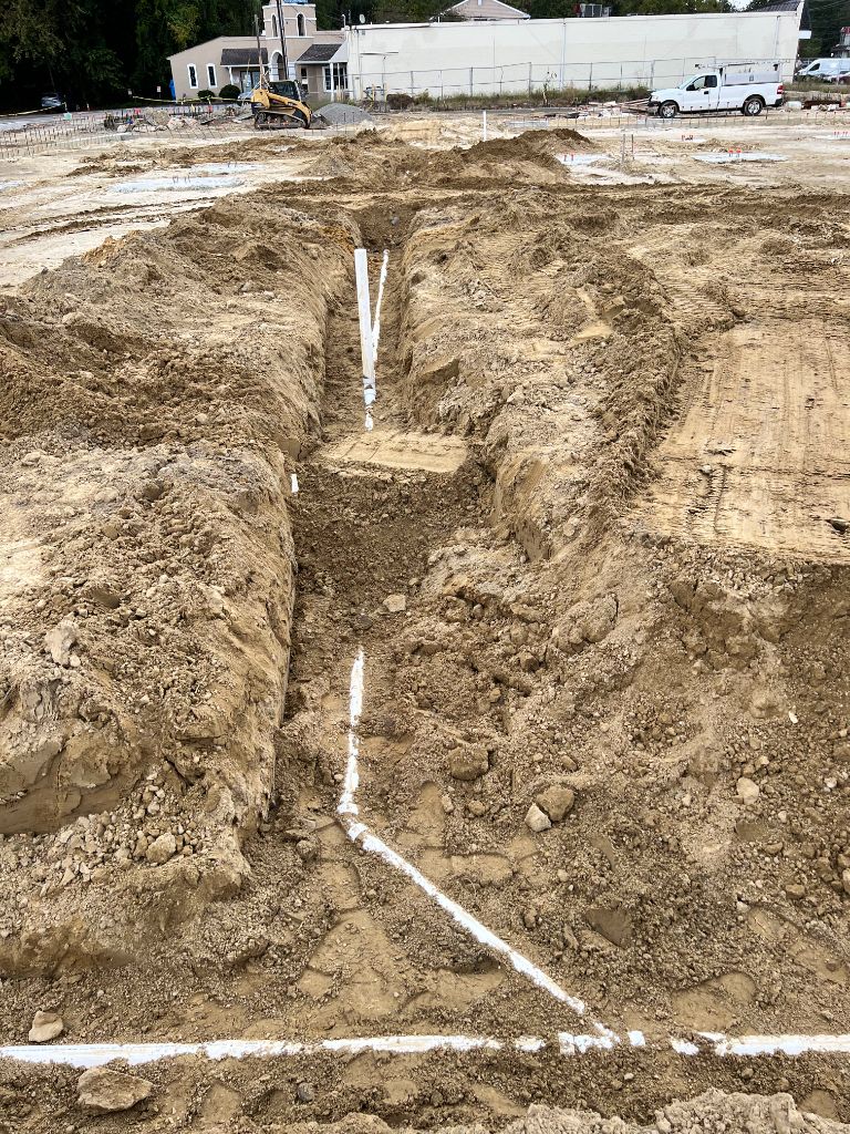 Commercial site deep slab trench with PVC drain lines