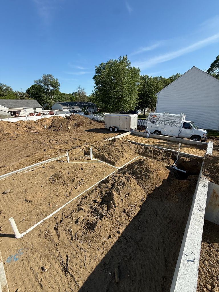 Legacy Plumbing van — PVC underground drain layout across full foundation