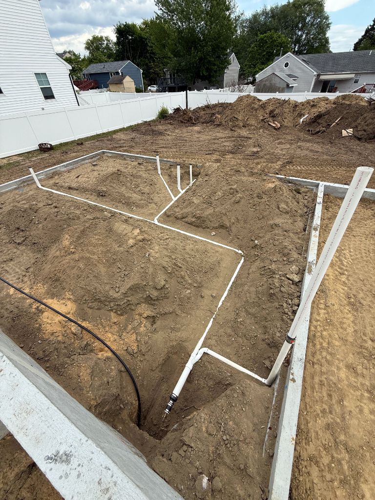 Large slab foundation with PVC vent stubs and drain lines