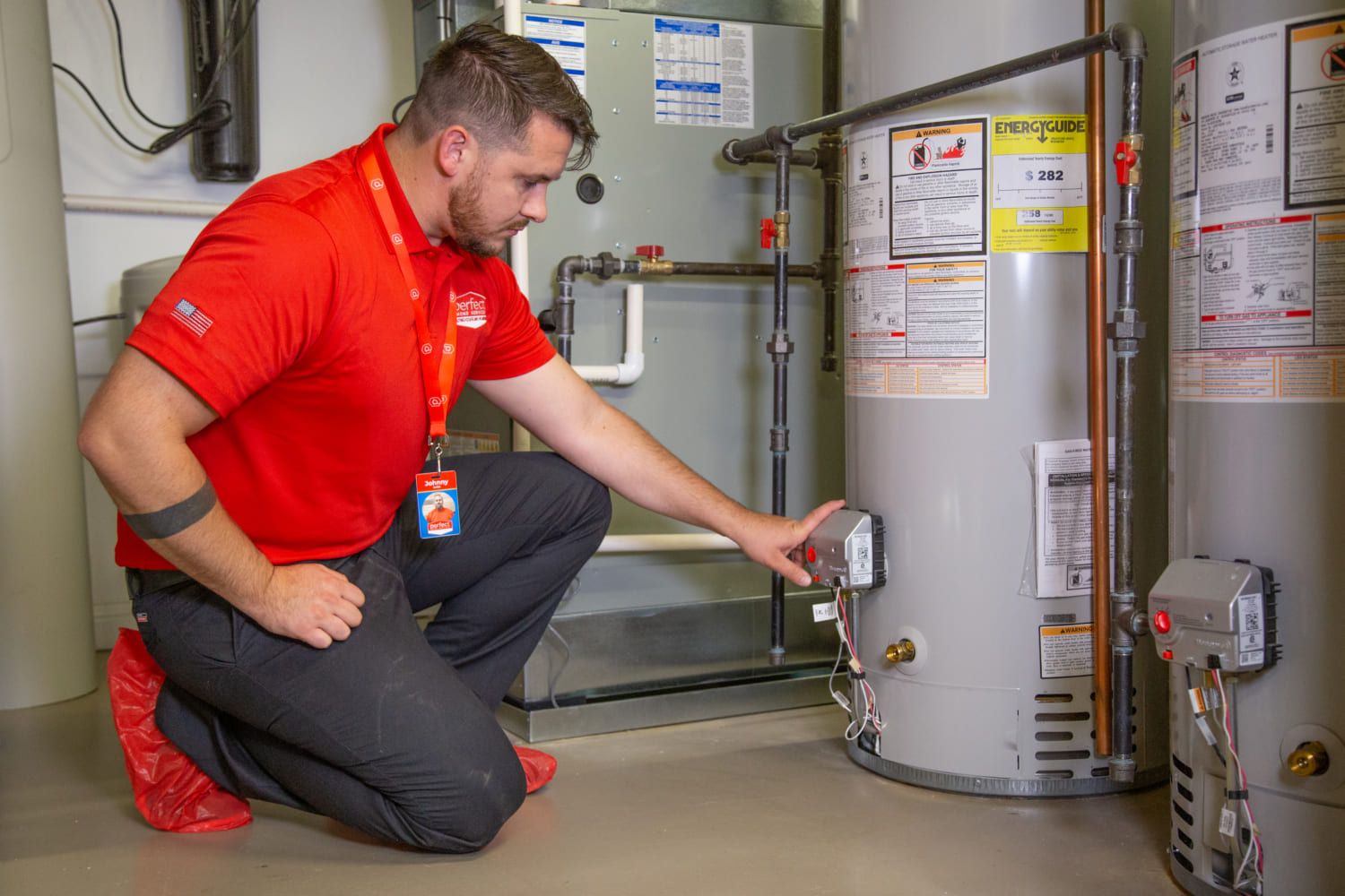 Technician servicing the gas control valve on a tank water heater