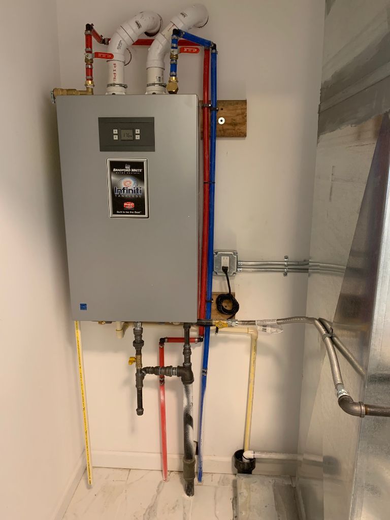 Bradford White Infiniti tankless water heater installed with PEX supply lines and PVC venting